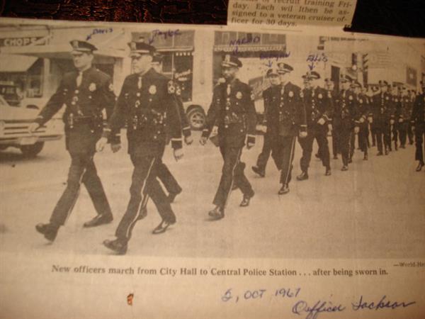 Scanned image of police officers marching from city hall to central police station in 1967